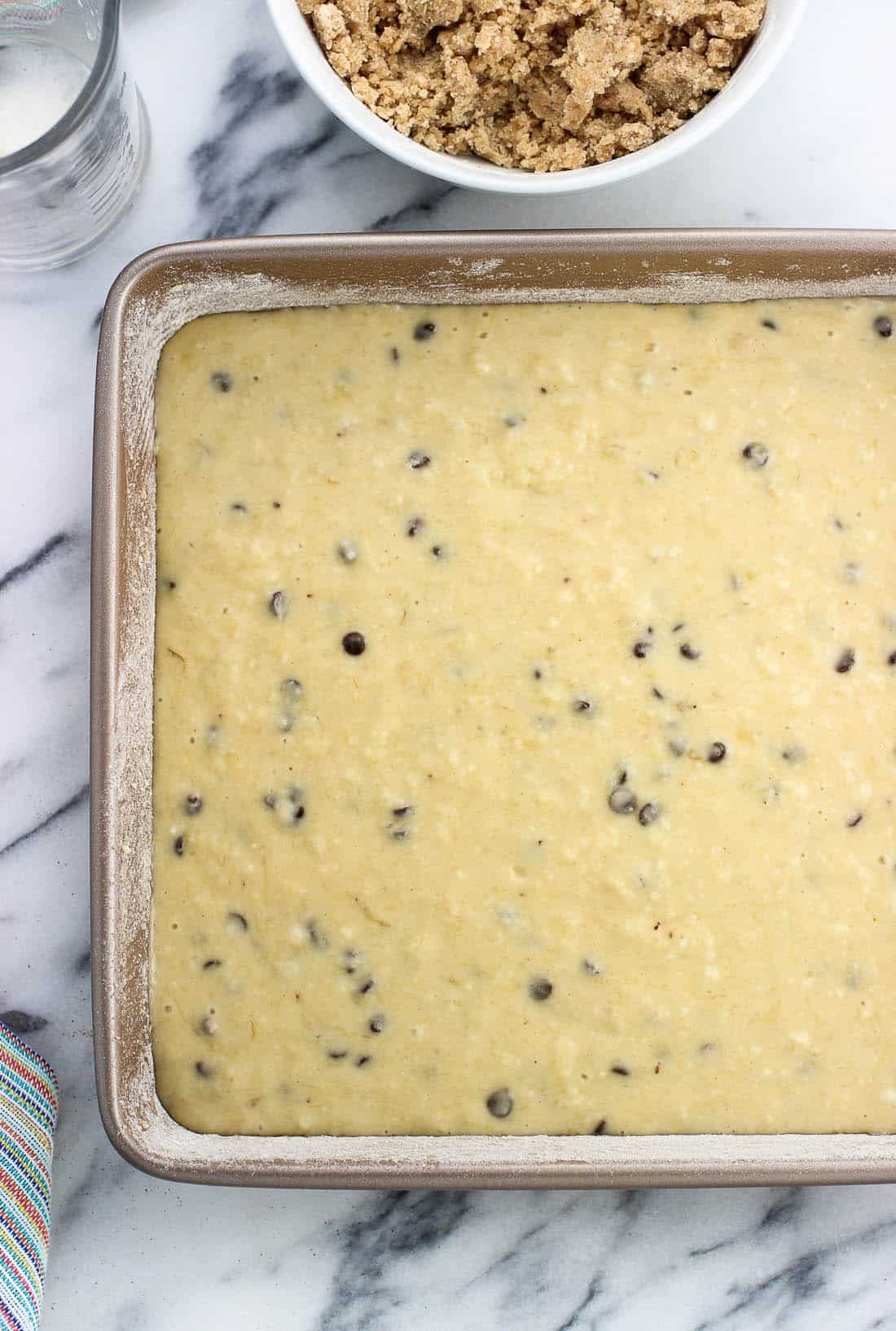 Cake batter poured into a greased and floured square pan.