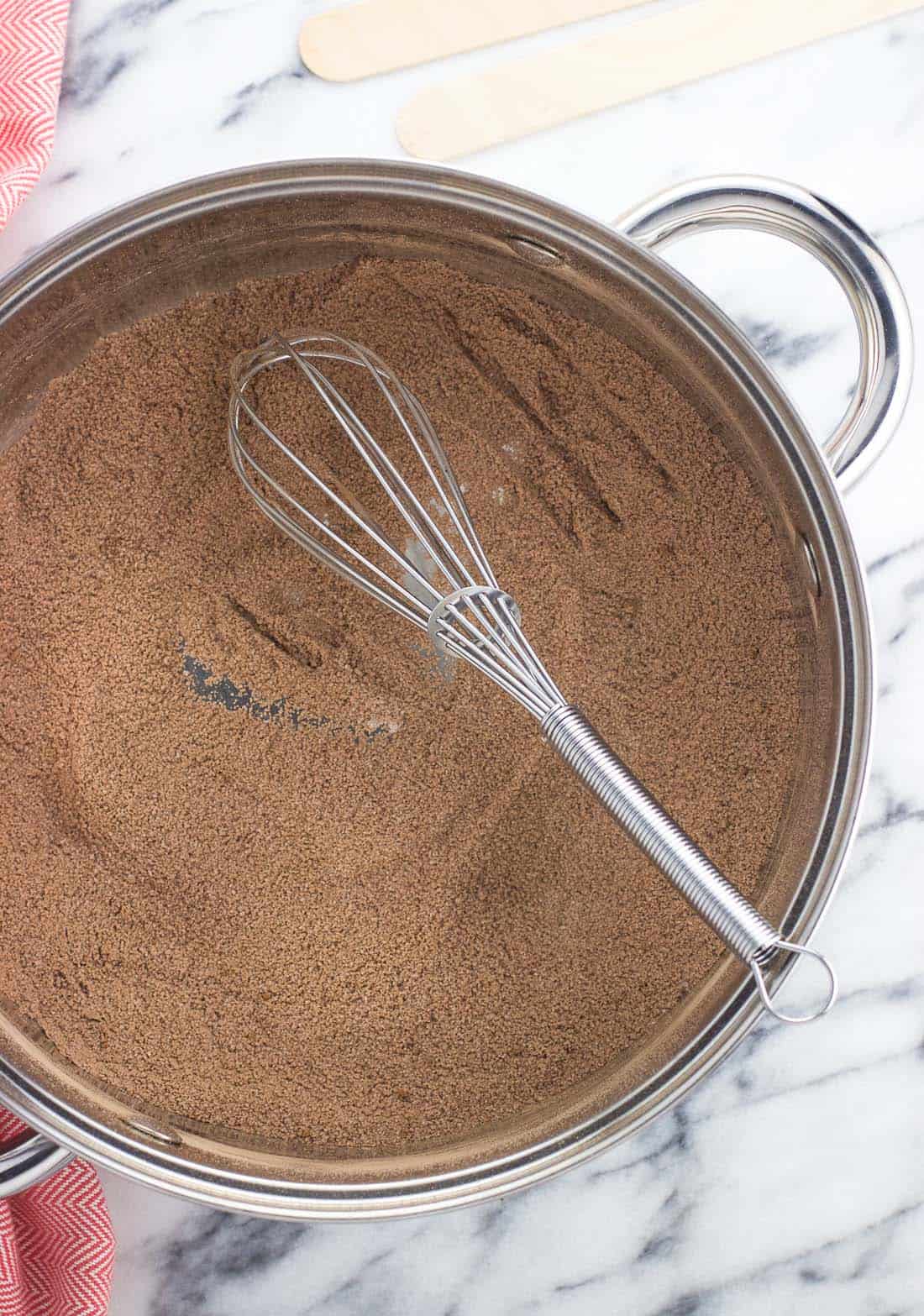 Sugar, cocoa powder, and cornstarch stirred together in a medium saucepan with a metal whisk