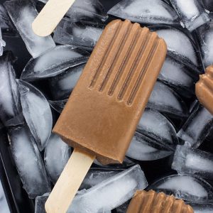 A close-up of a fudgesicle on a bed of ice