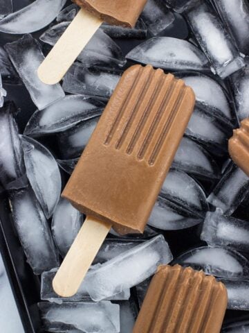 A close-up of a fudgesicle on a bed of ice