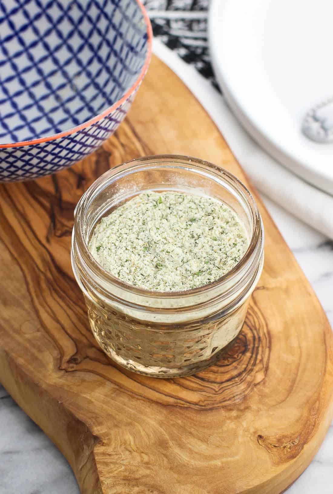 A small glass jar of mixed ranch seasoning.