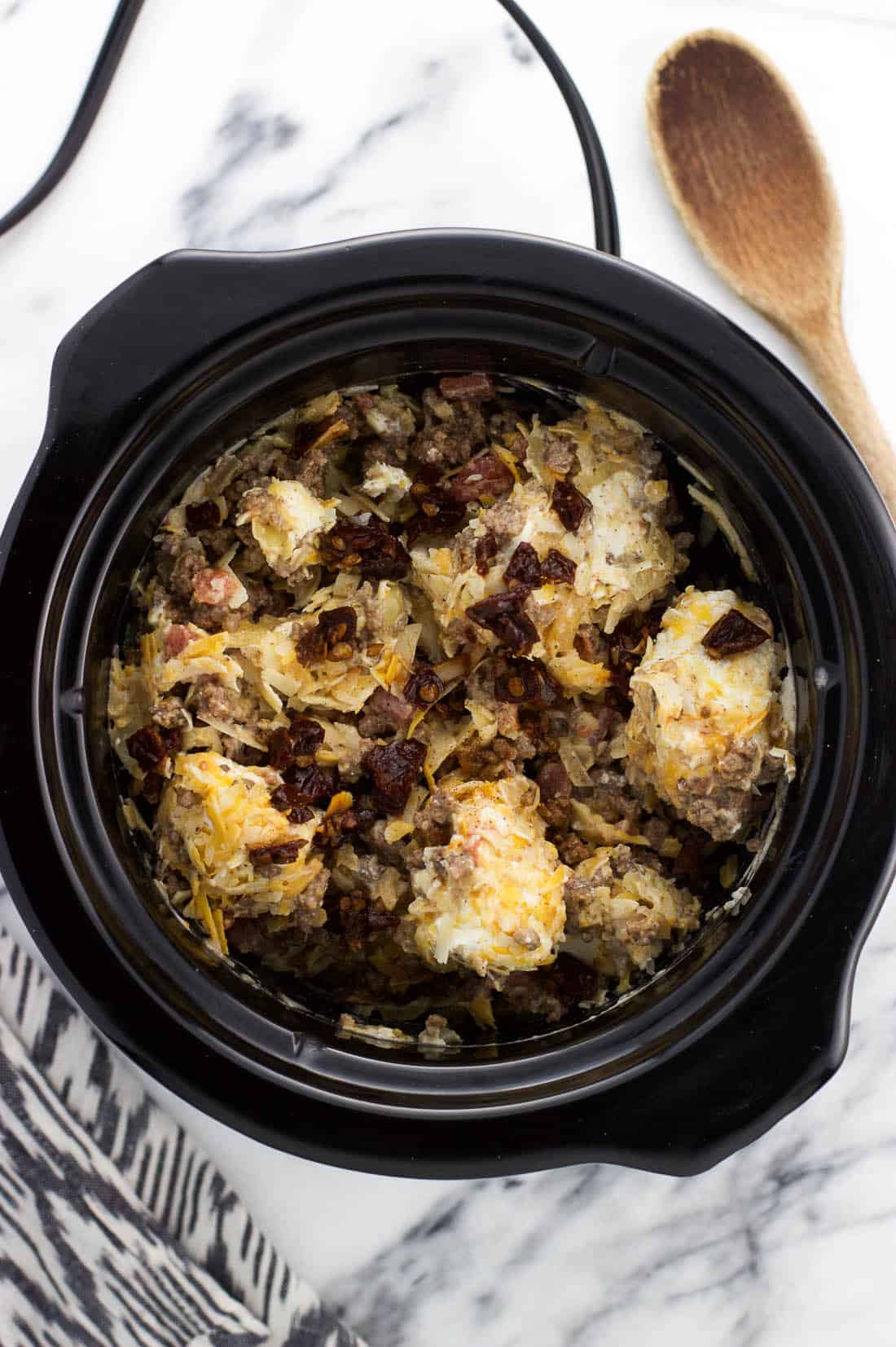 Recipe ingredients in a small slow cooker before melting and combining.