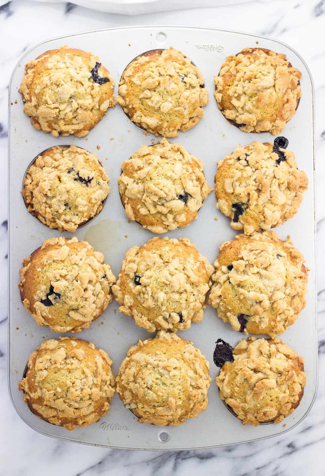 An overhead picture of twelve muffins baked in a muffin tin