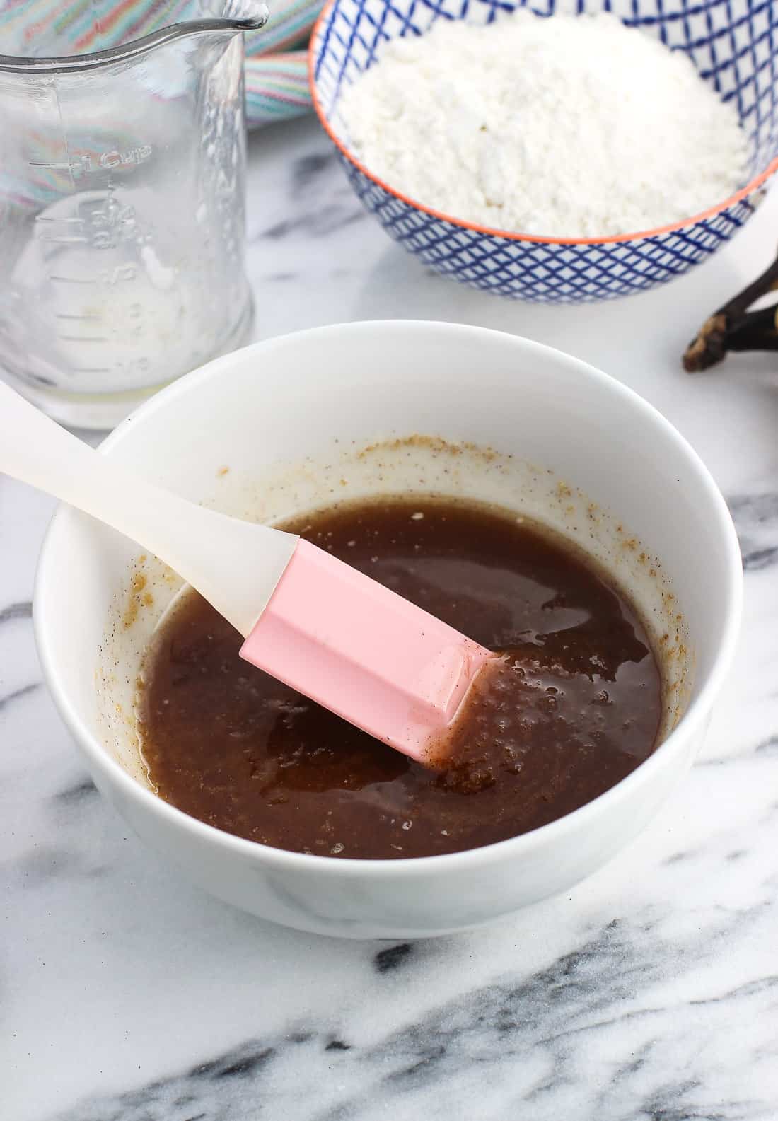 The liquid crumb topping mixture in a bowl with a spatula before adding the flour.