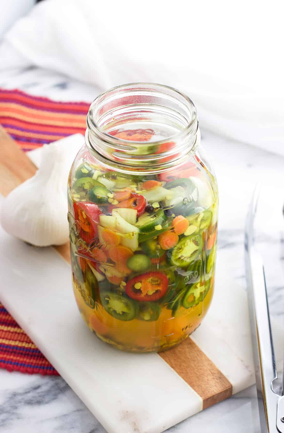 A Ball glass jar filled with the refrigerator pickled peppers
