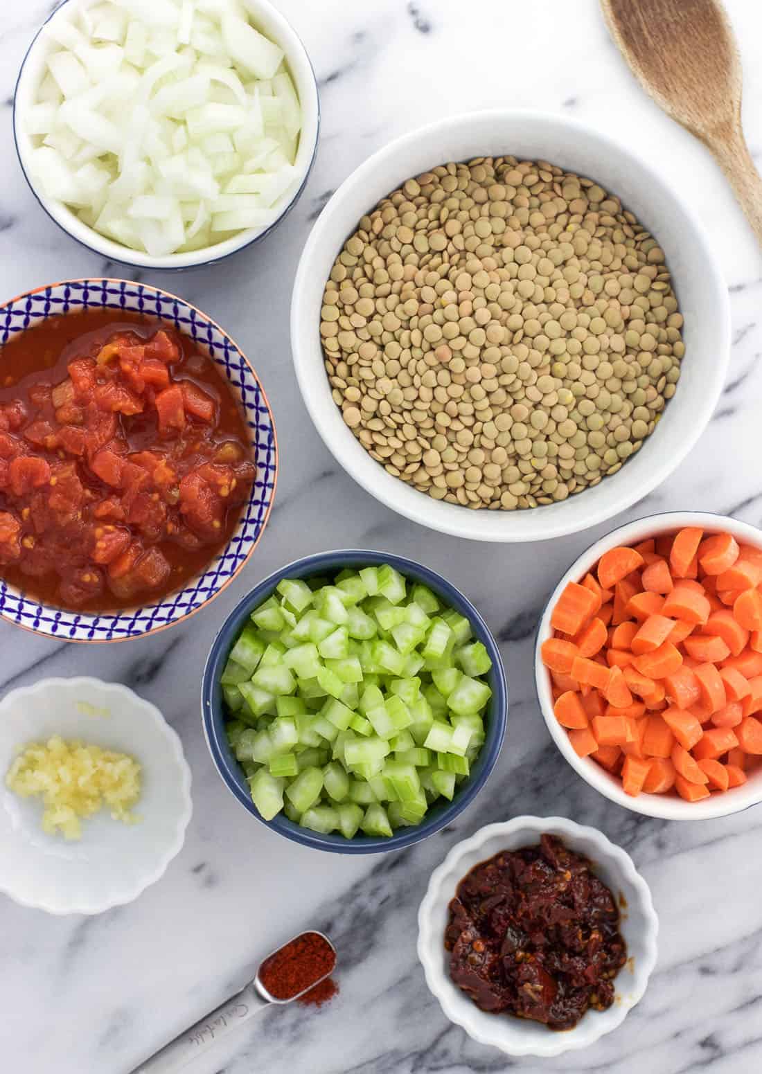 An overhead shot of all of the soup ingredients in separate bowls.