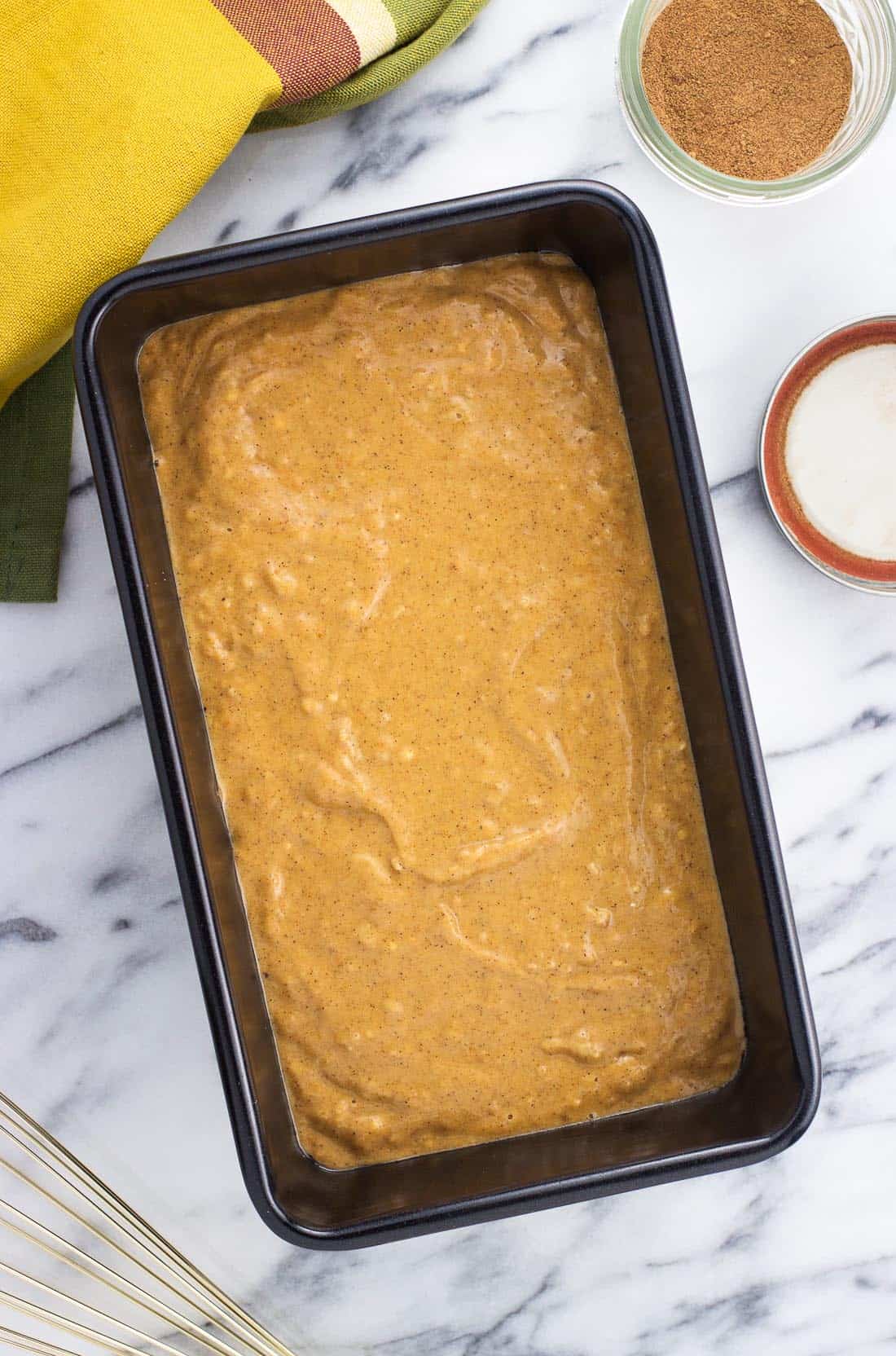 An overhead shot of the batter in a loaf pan before baking