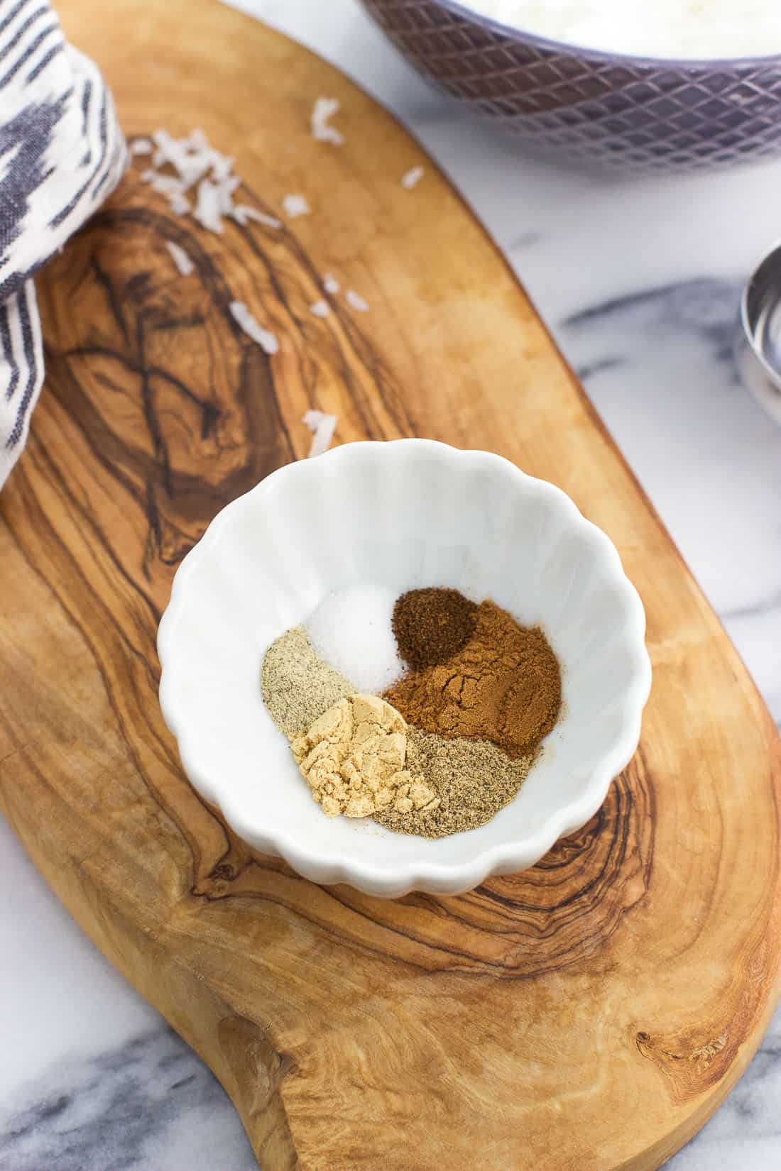 Chai spices in a small glass bowl before being mixed together.