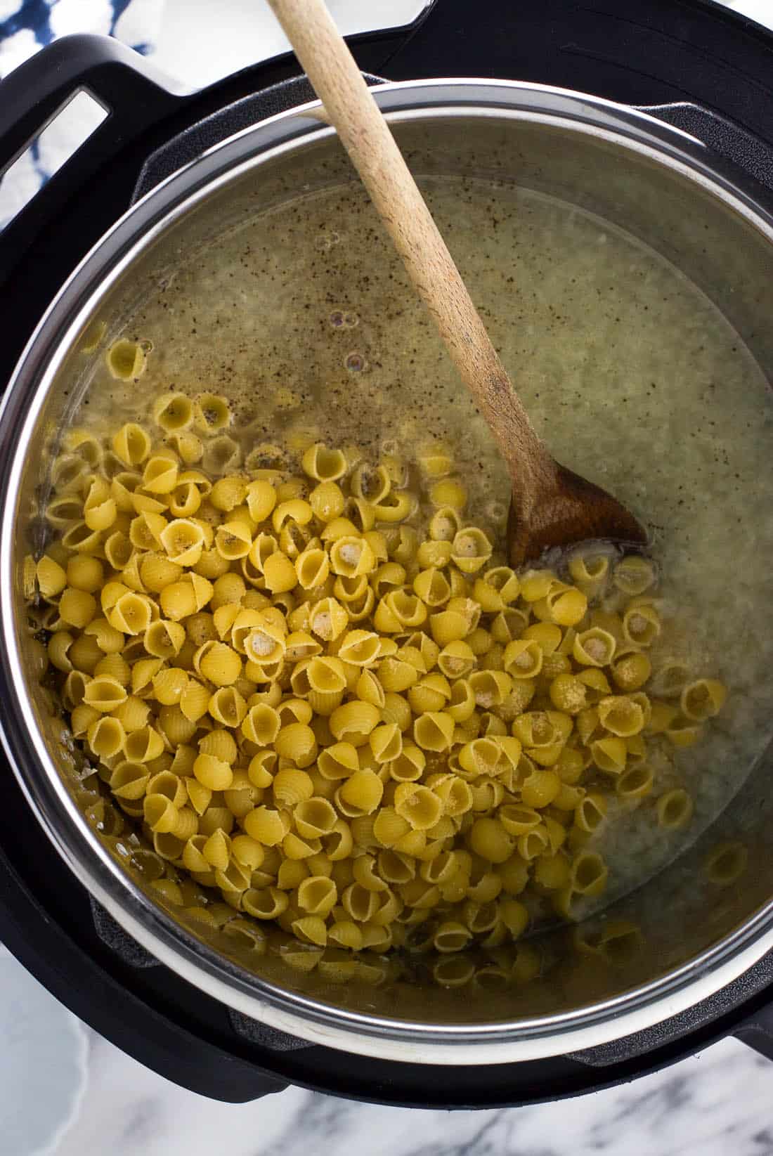 All of the ingredients through the pasta added to the Instant Pot insert before pressure cooking.