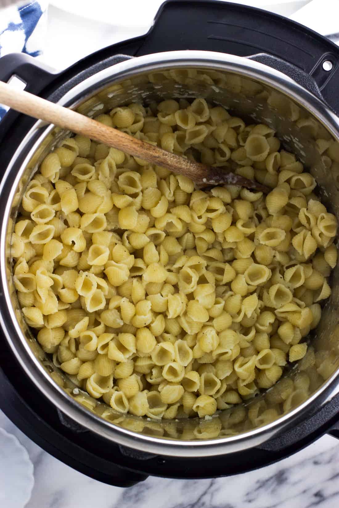 Cooked pasta in the Instant Pot insert after pressure cooking and before stirring in milk and cheese.