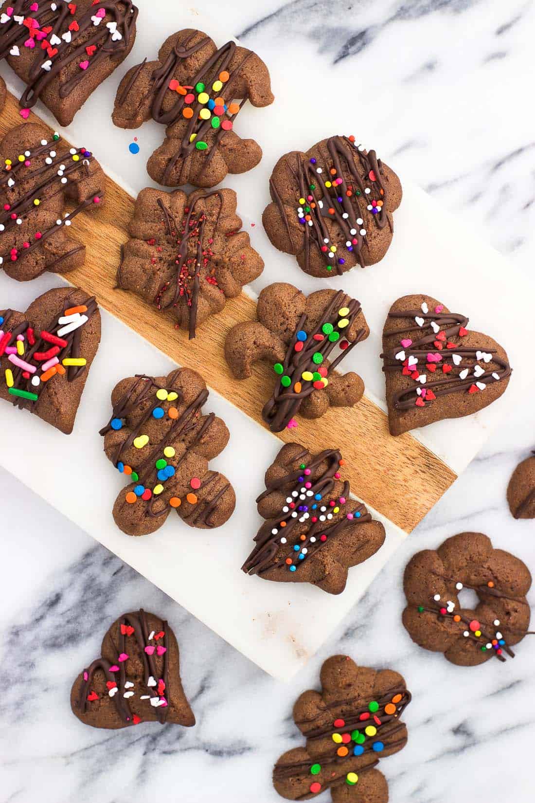 An overhead shot of chocolate cookies on a marble board.