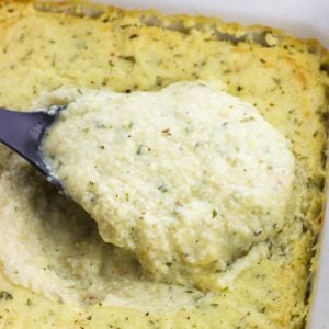 A big spoonful of grits being lifted out of the pan