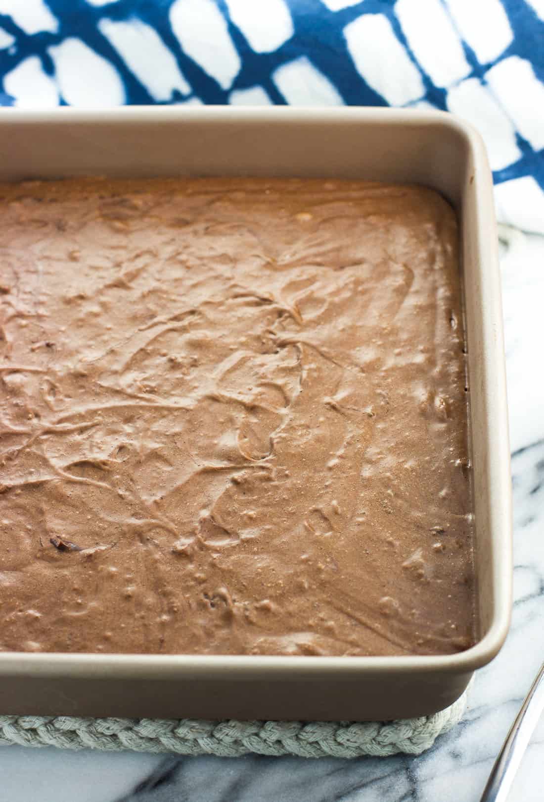 Cookie batter in a metal 8" x 8" baking dish after freezing