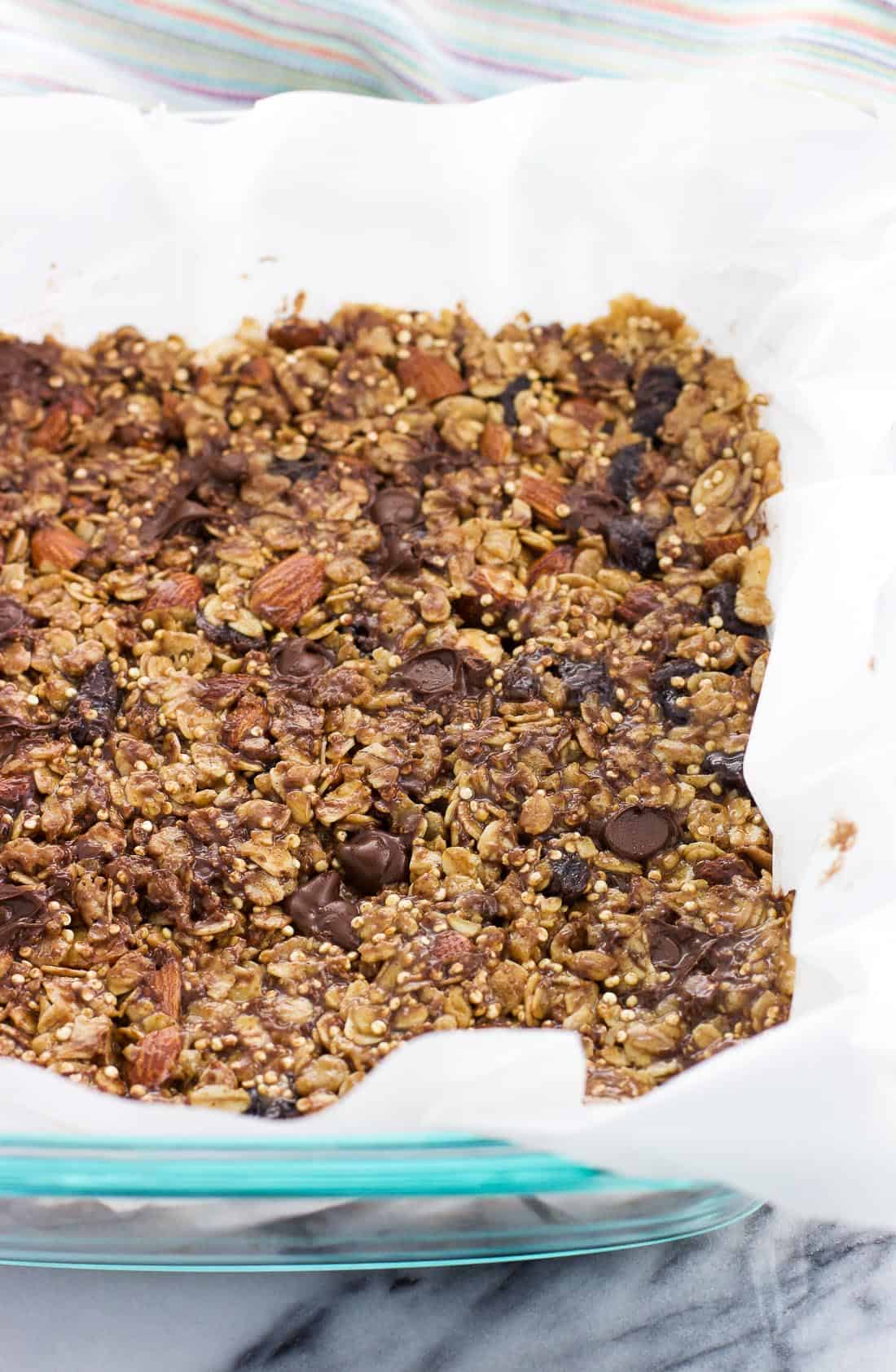 The bar mixture pressed into a parchment paper-lined dish