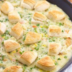 Fish pot pie topped with biscuit pieces in a skillet.