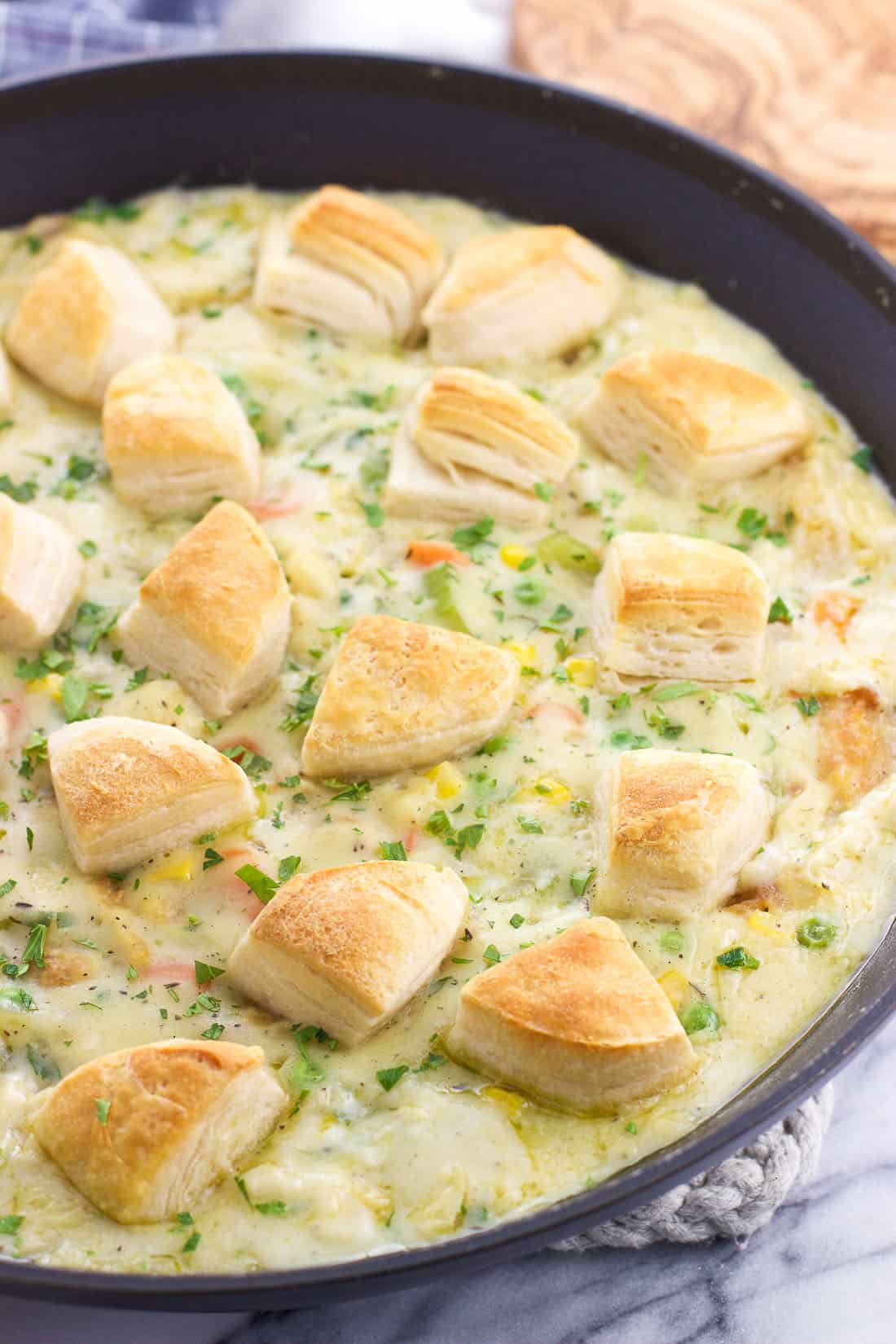 The skillet pot pie topped with cooked biscuit segments ready to be served