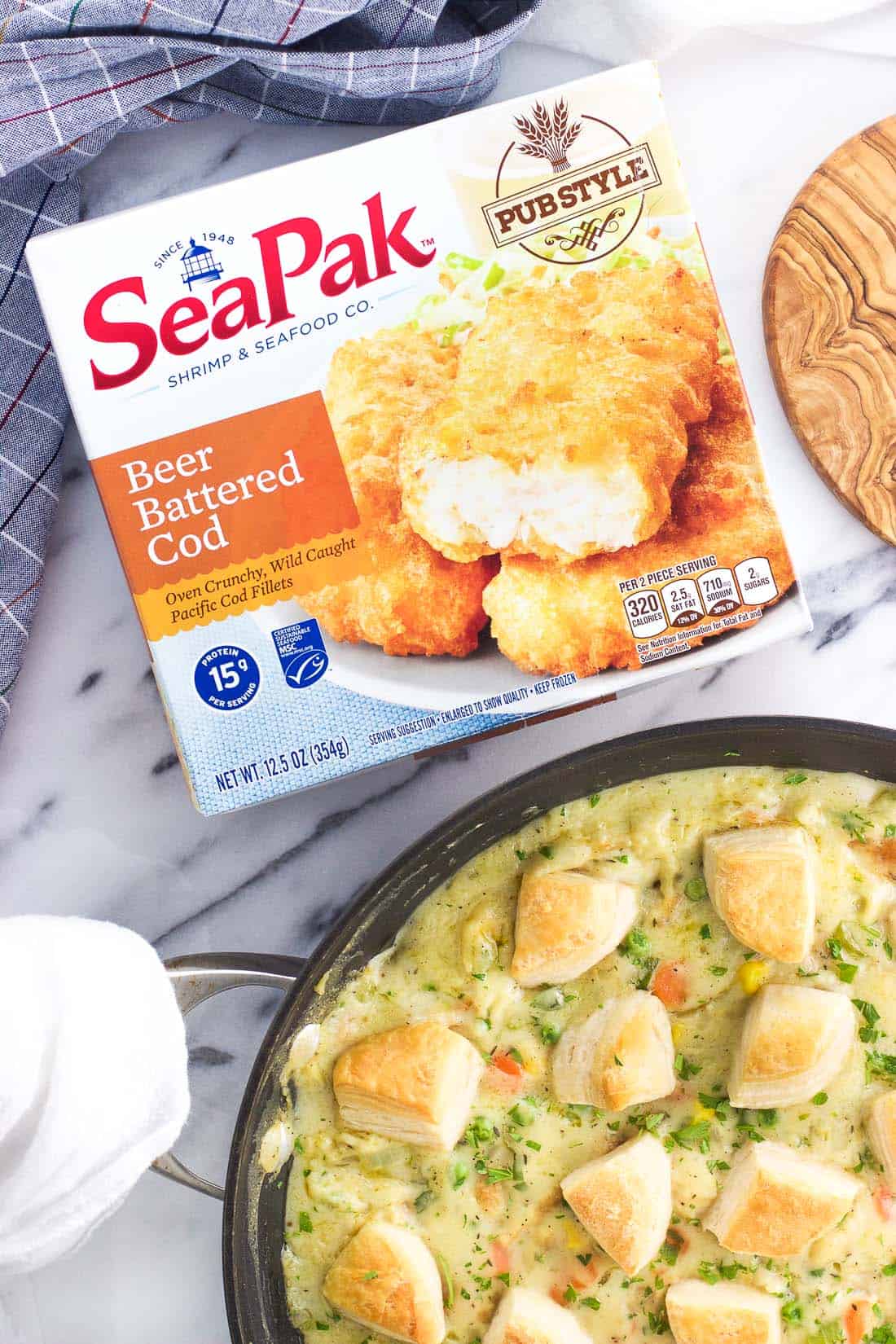 An overhead shot of a SeaPak beer battered cod package next to the skillet pot pie.