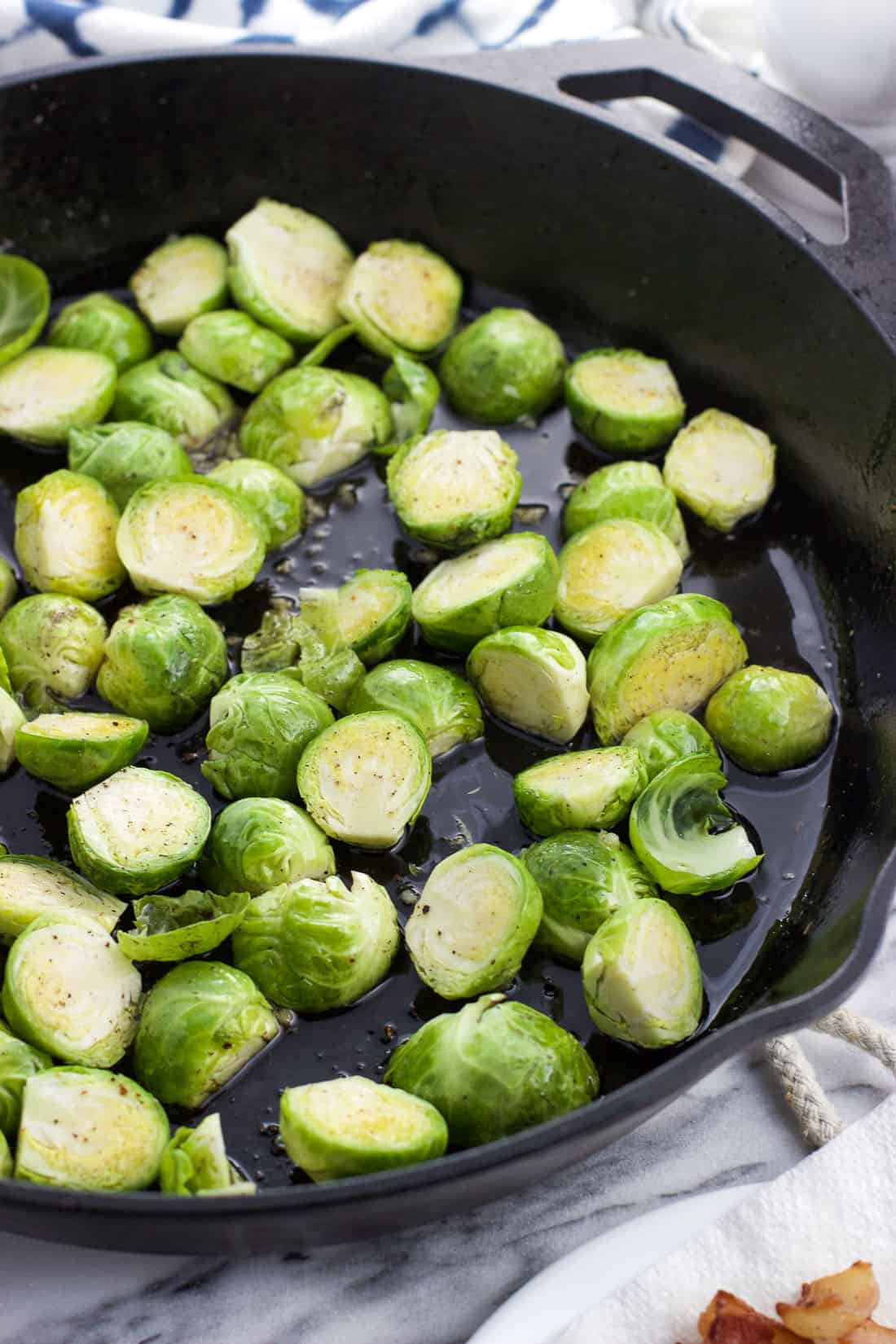 Halved brussels sprouts in a cast iron skillet