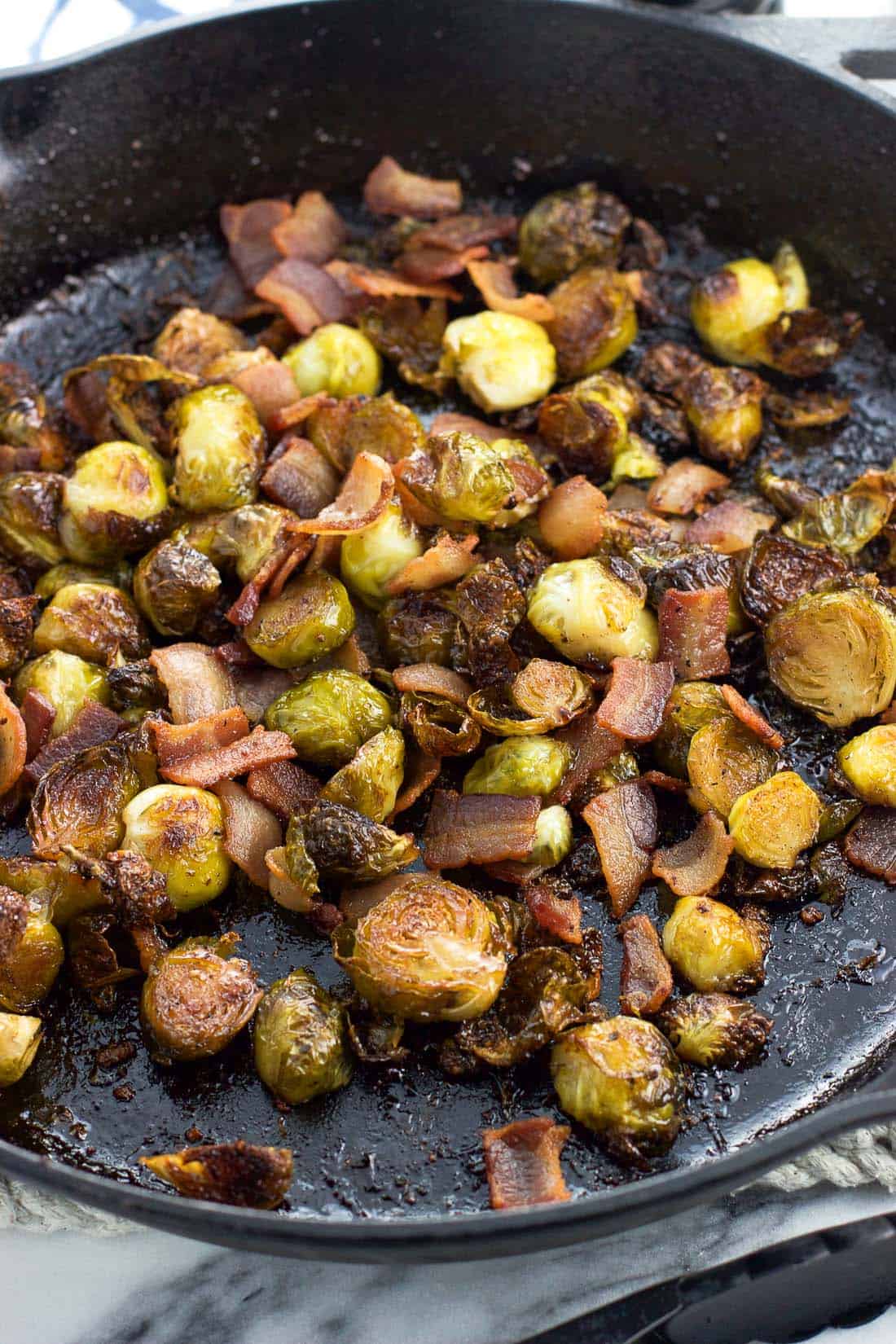 Maple bacon brussels sprouts in a cast iron skillet after roasting