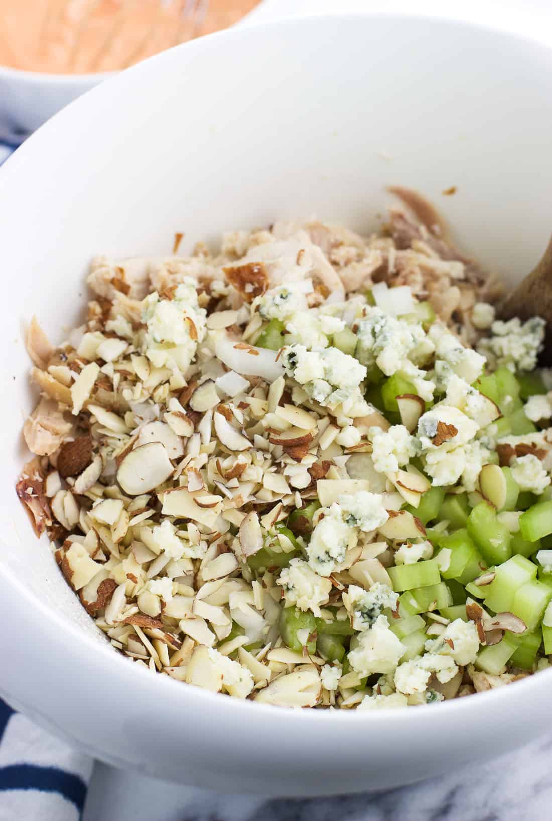 Buffalo chicken salad ingredients in a mixing bowl