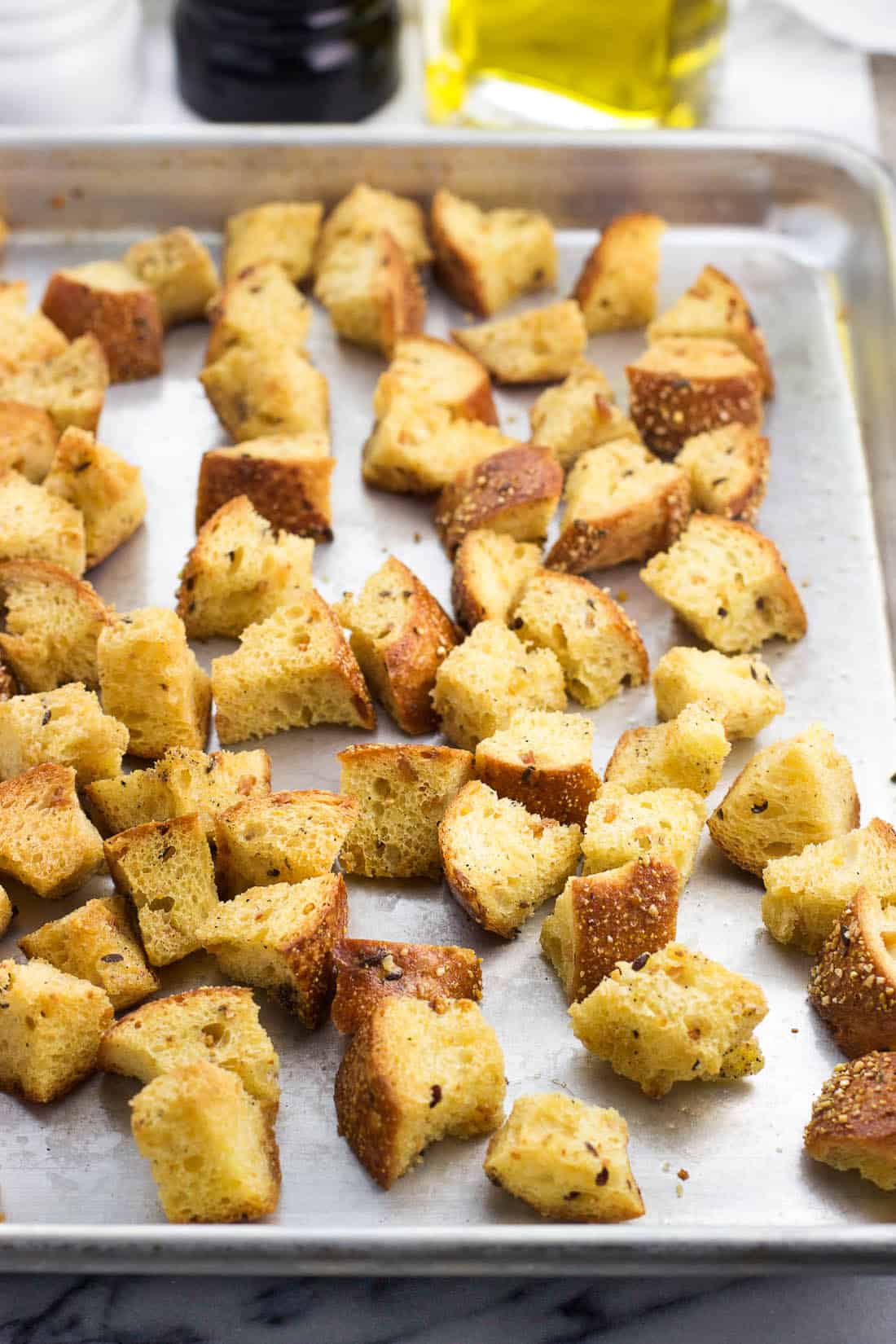 Baked croutons on a metal baking sheet