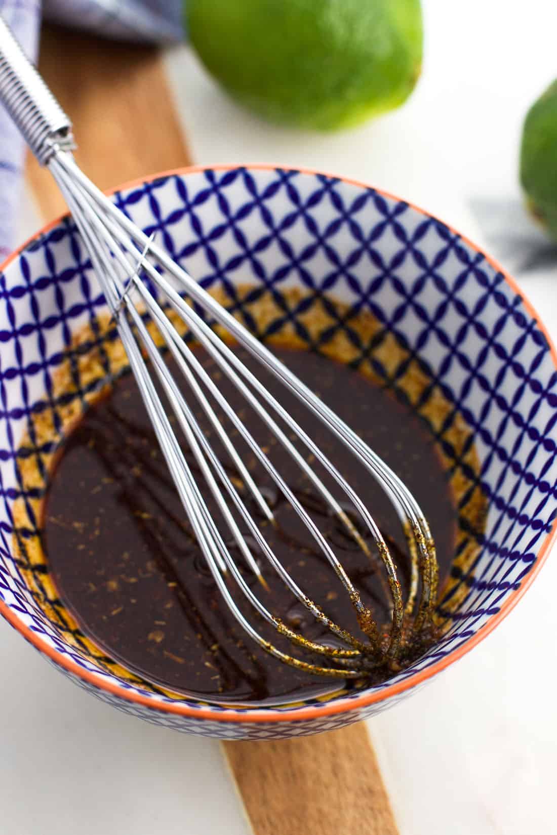 Whisked together chili lime glaze in a small bowl with a whisk