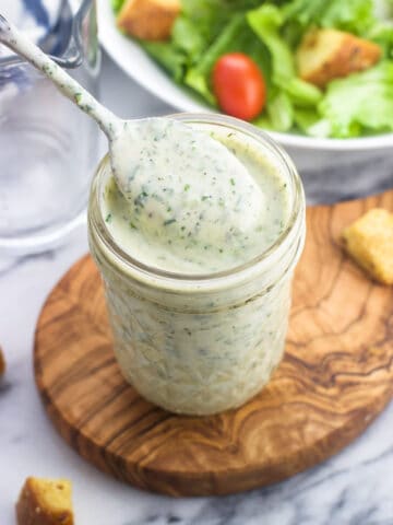 Cilantro lime ranch in a glass jar with a spoon