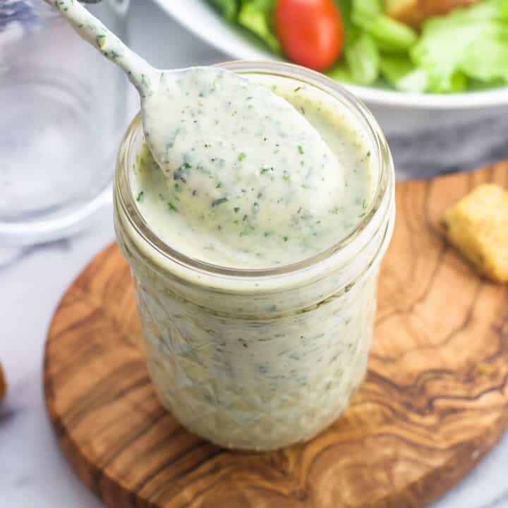 Cilantro lime ranch in a glass jar with a spoon