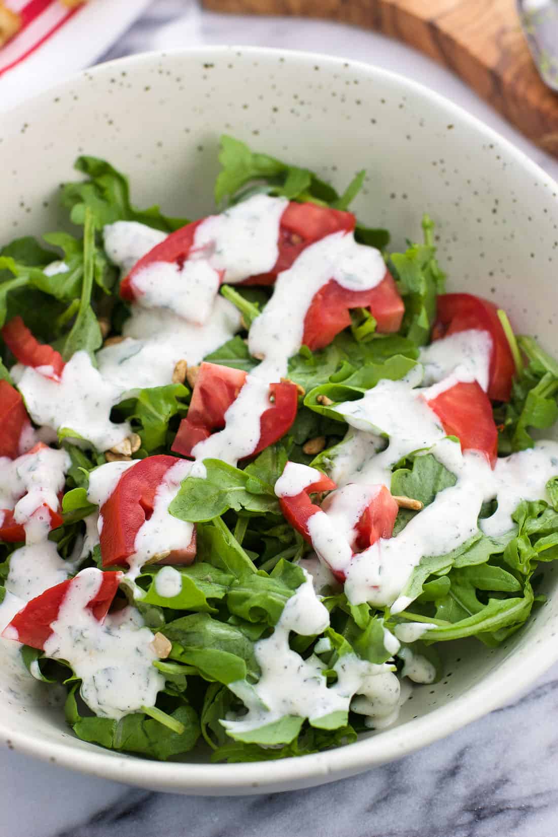 Salad in a bowl with a healthy cilantro lime ranch dressing drizzle