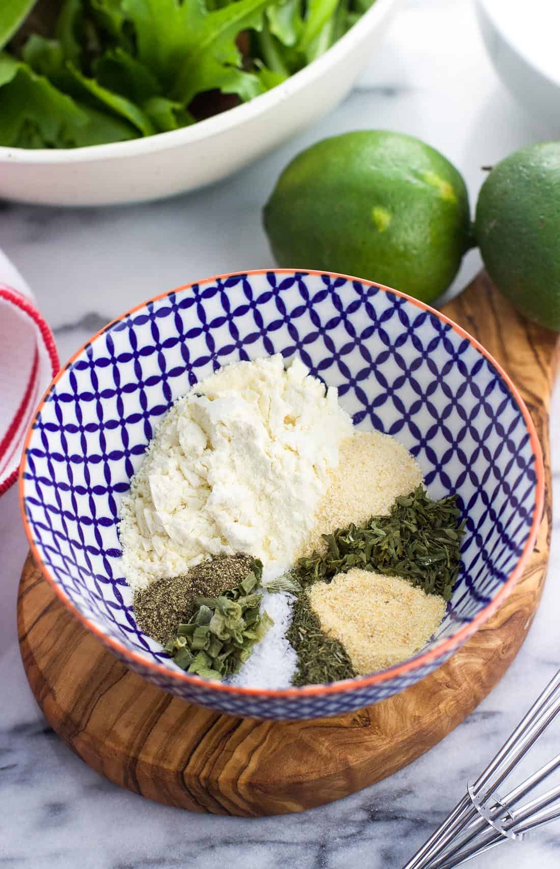 The herbs and spices used in homemade ranch dressing in a small bowl