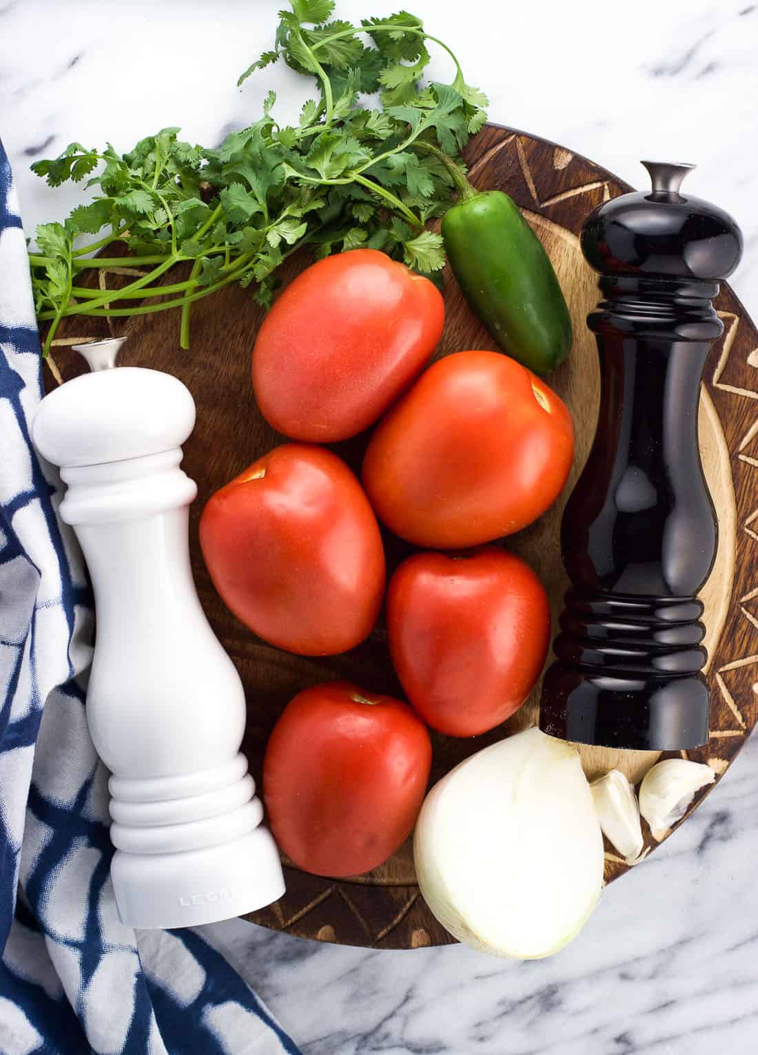 Raw pico de gallo ingredients on a wooden serving board.