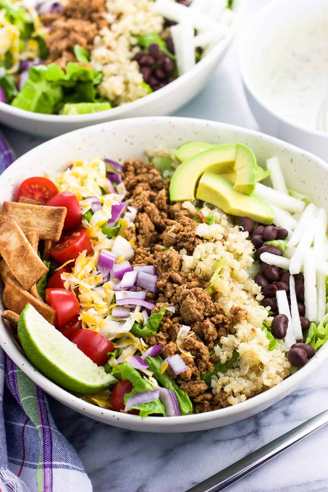 A side profile shot of the taco salad in a bowl with a fork