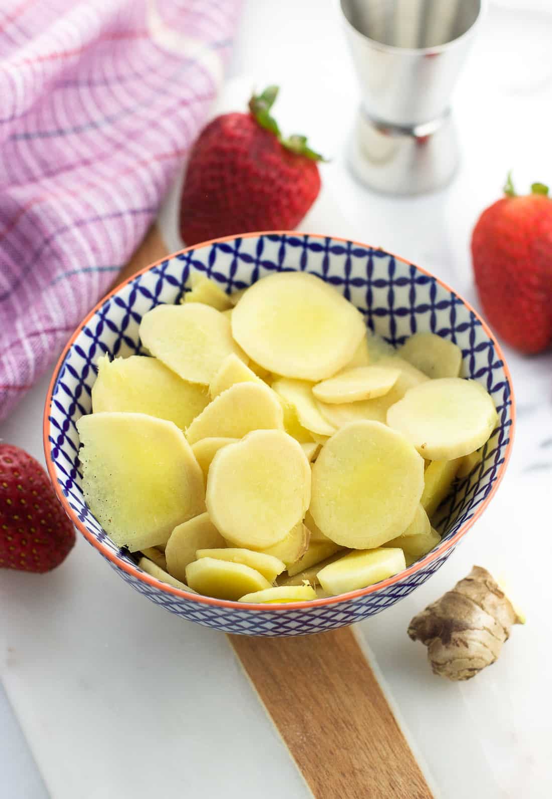 Fresh ginger slices in a small bowl