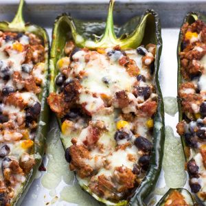 Healthy stuffed poblano peppers on a metal baking sheet