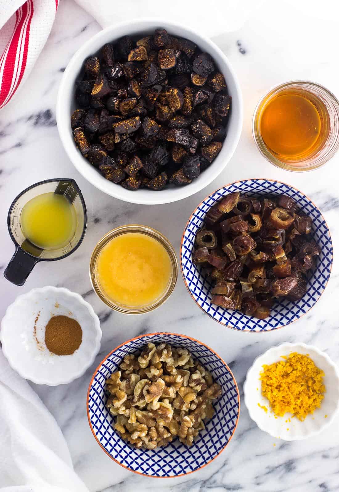 Cucidati ingredients in separate bowls on a marble board