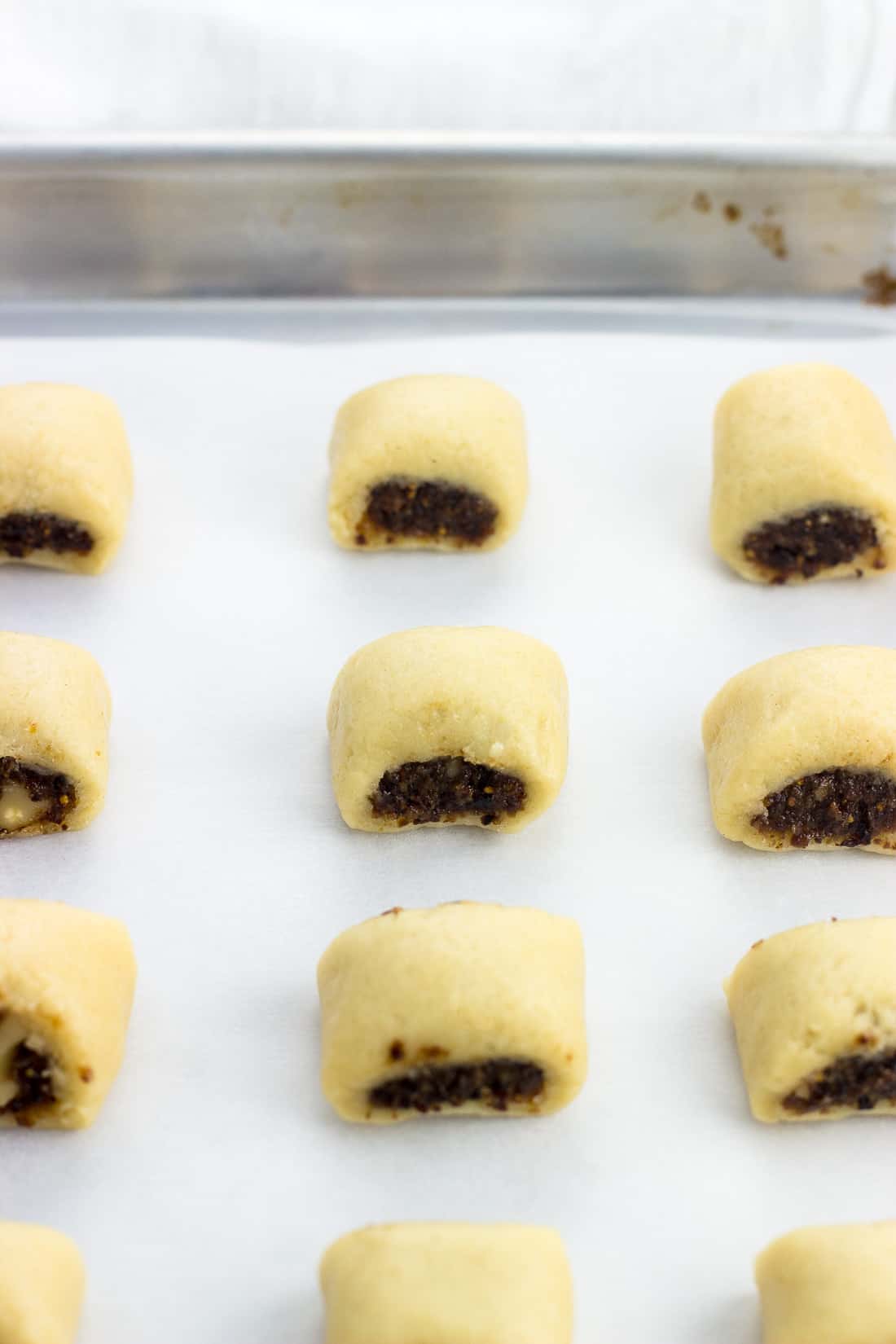 Italian fig cookies on a parchment lined baking sheet pre-bake