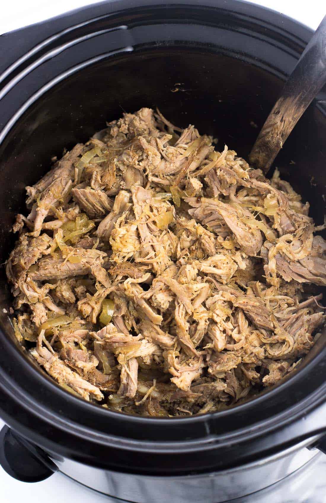 Shredded pulled pork in the slow cooker ready to serve