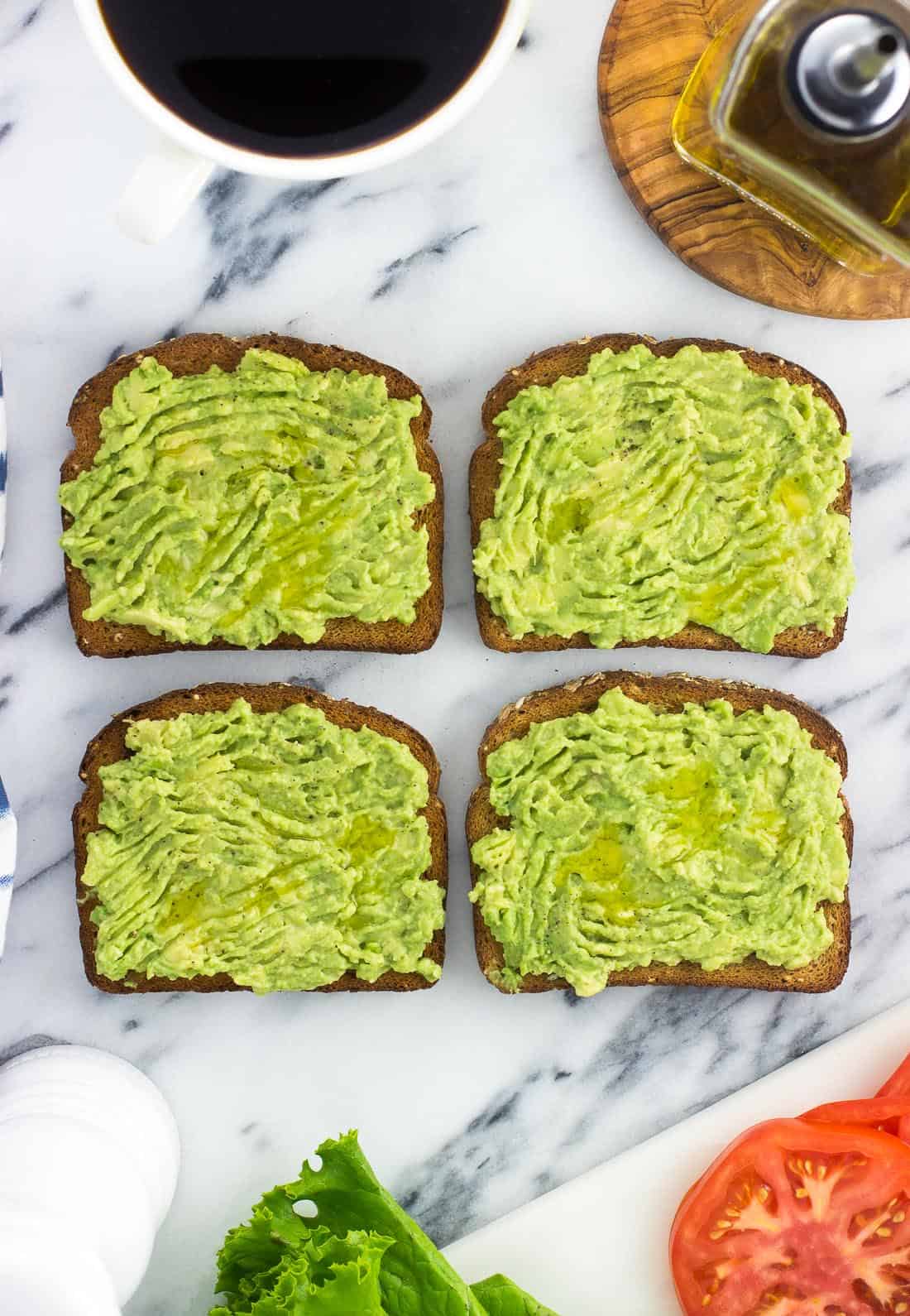 Four slices of avocado toast before adding toppings