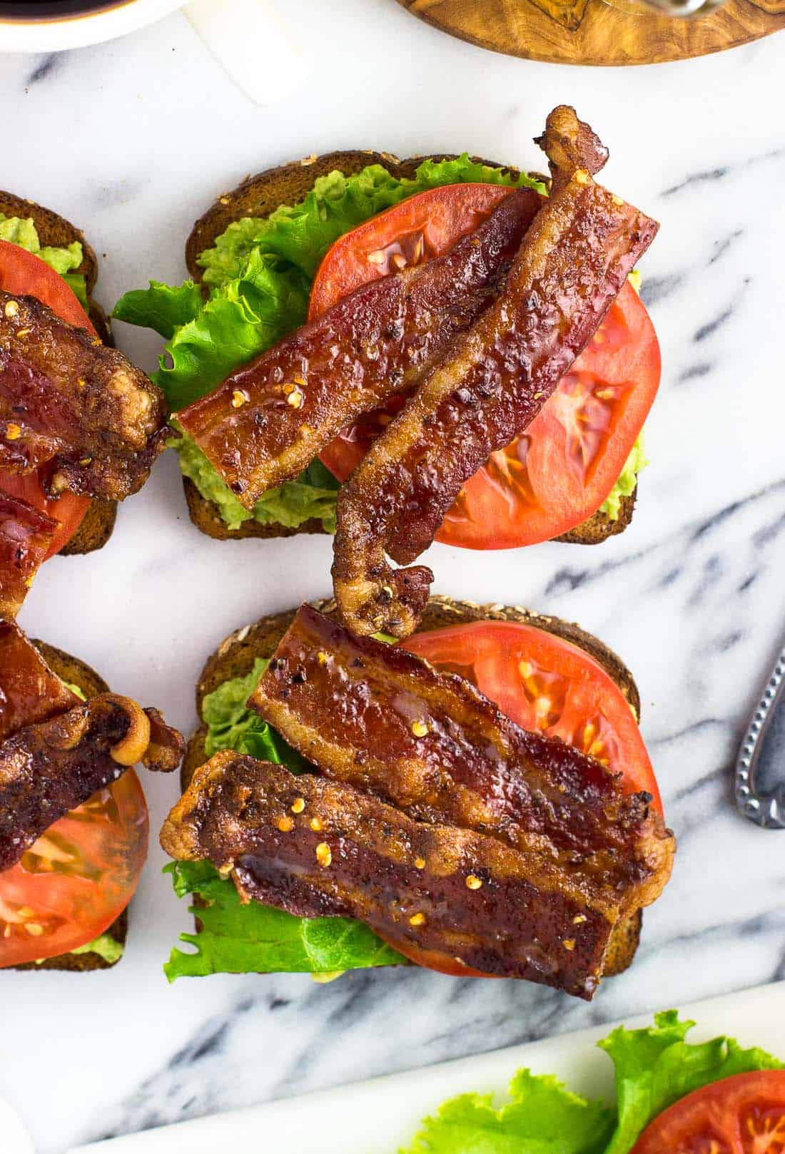 BLT Avocado Toast ready to serve on a marble board.