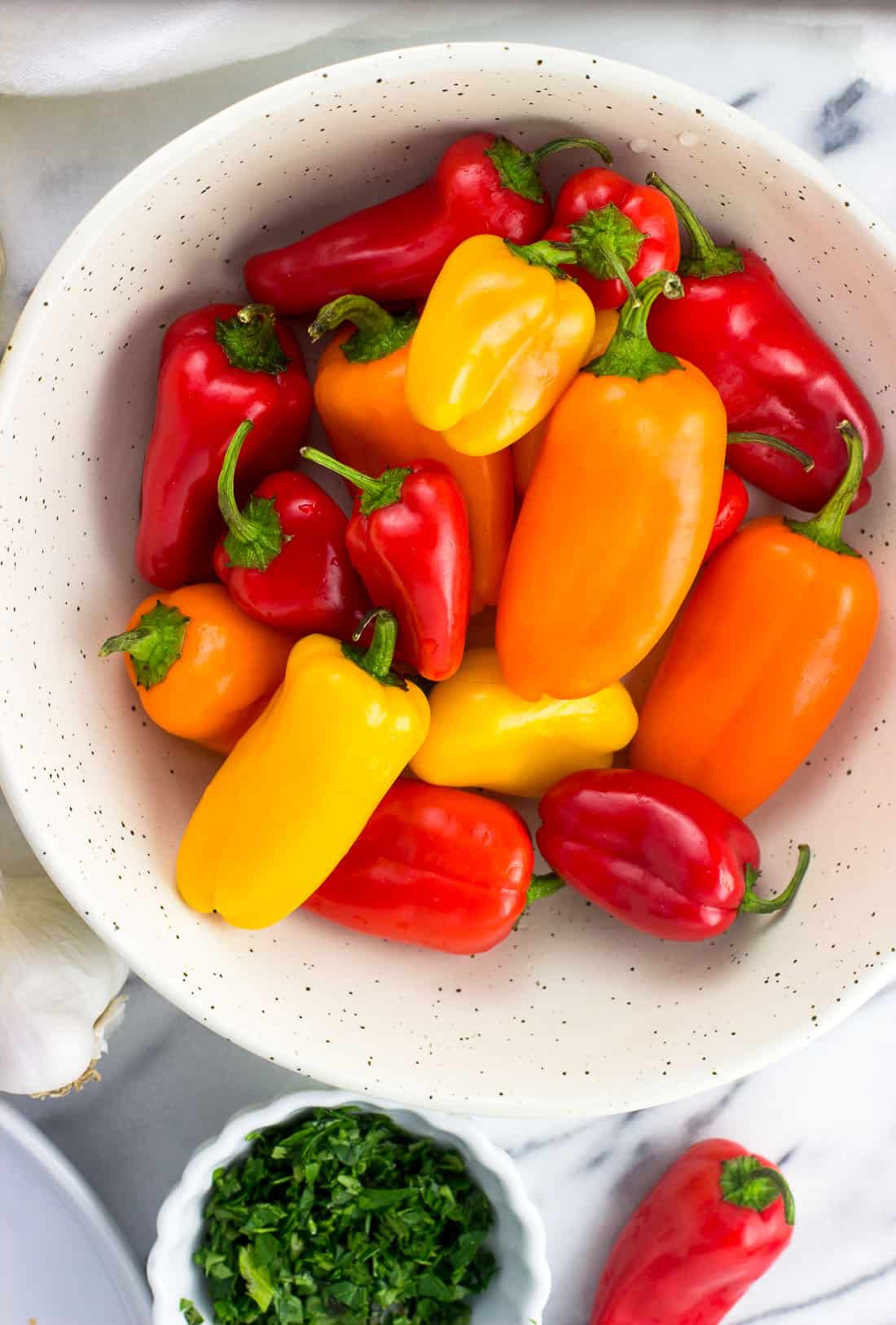 A close-up picture of a bowl of mini sweet peppers.