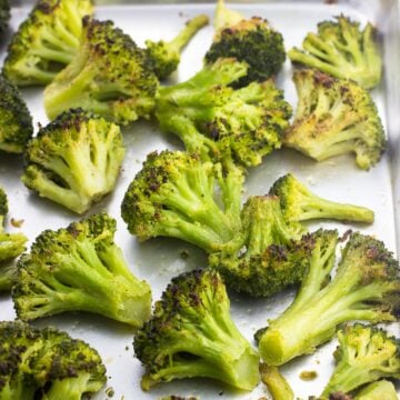 Roasted broccoli on a sheet pan after being in the oven