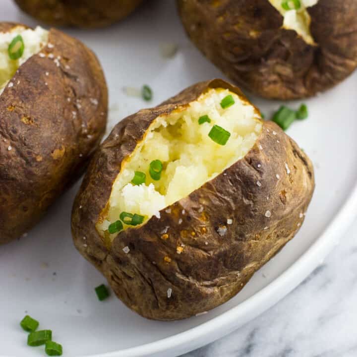 A close-up of an air fryer baked potato on a plate