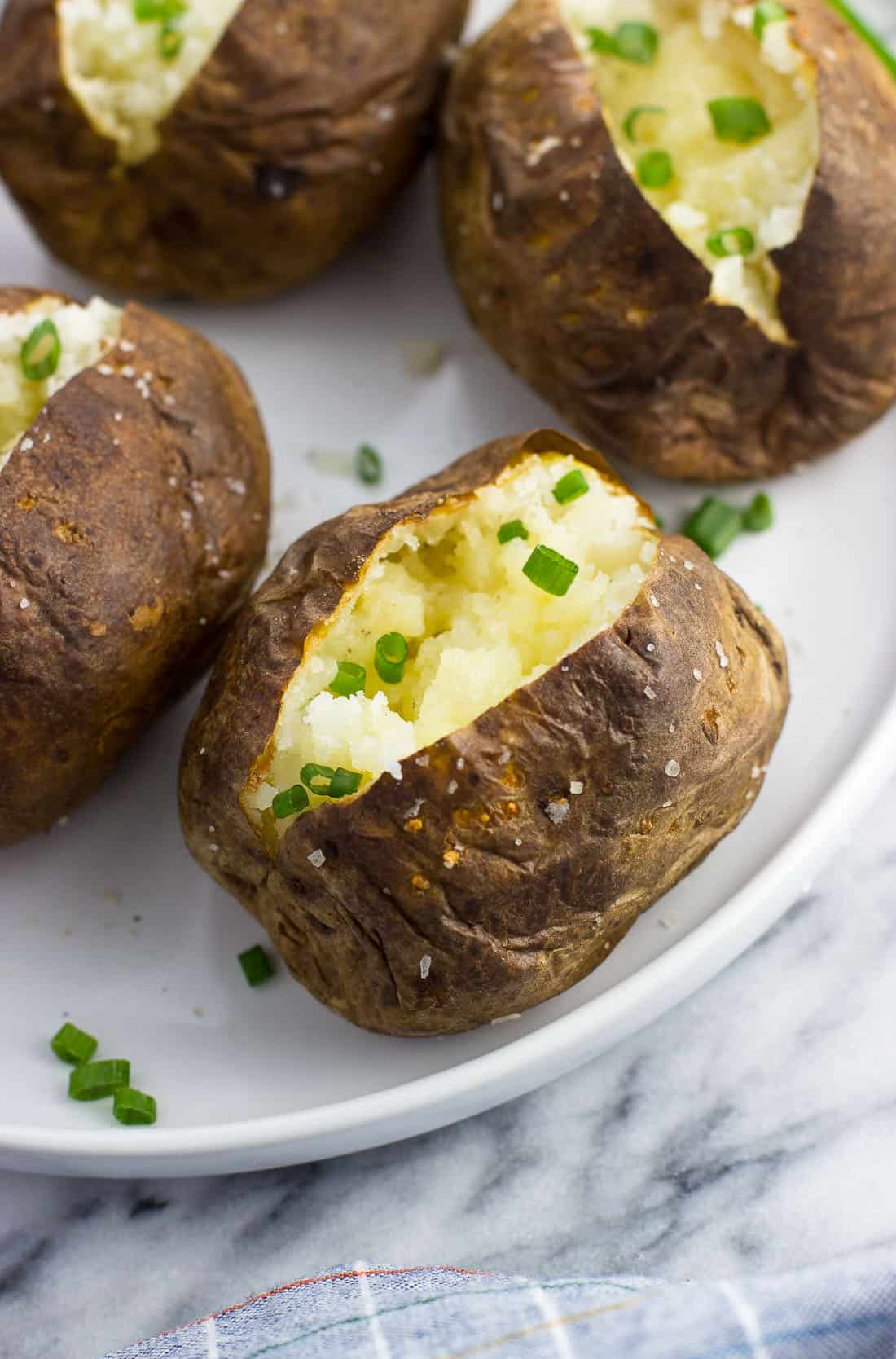 A close-up of an air fryer baked potato on a plate