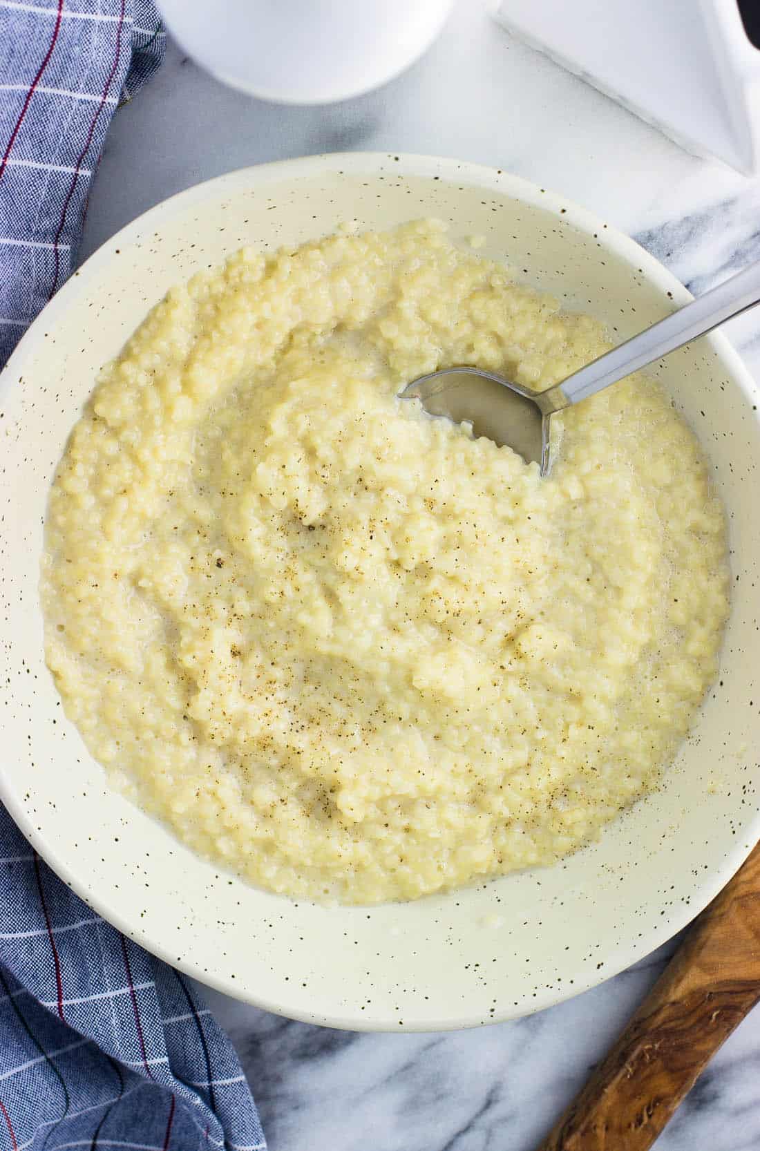 A bowl of pastina topped with cracked pepper