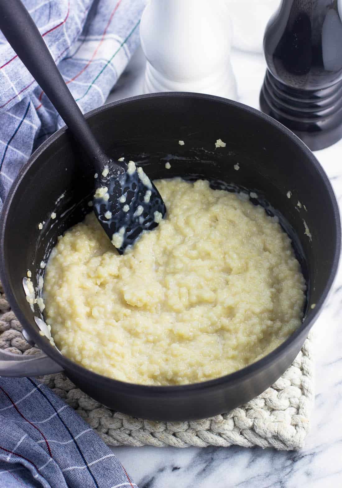 Cooked pastina in a saucepan with a spatula