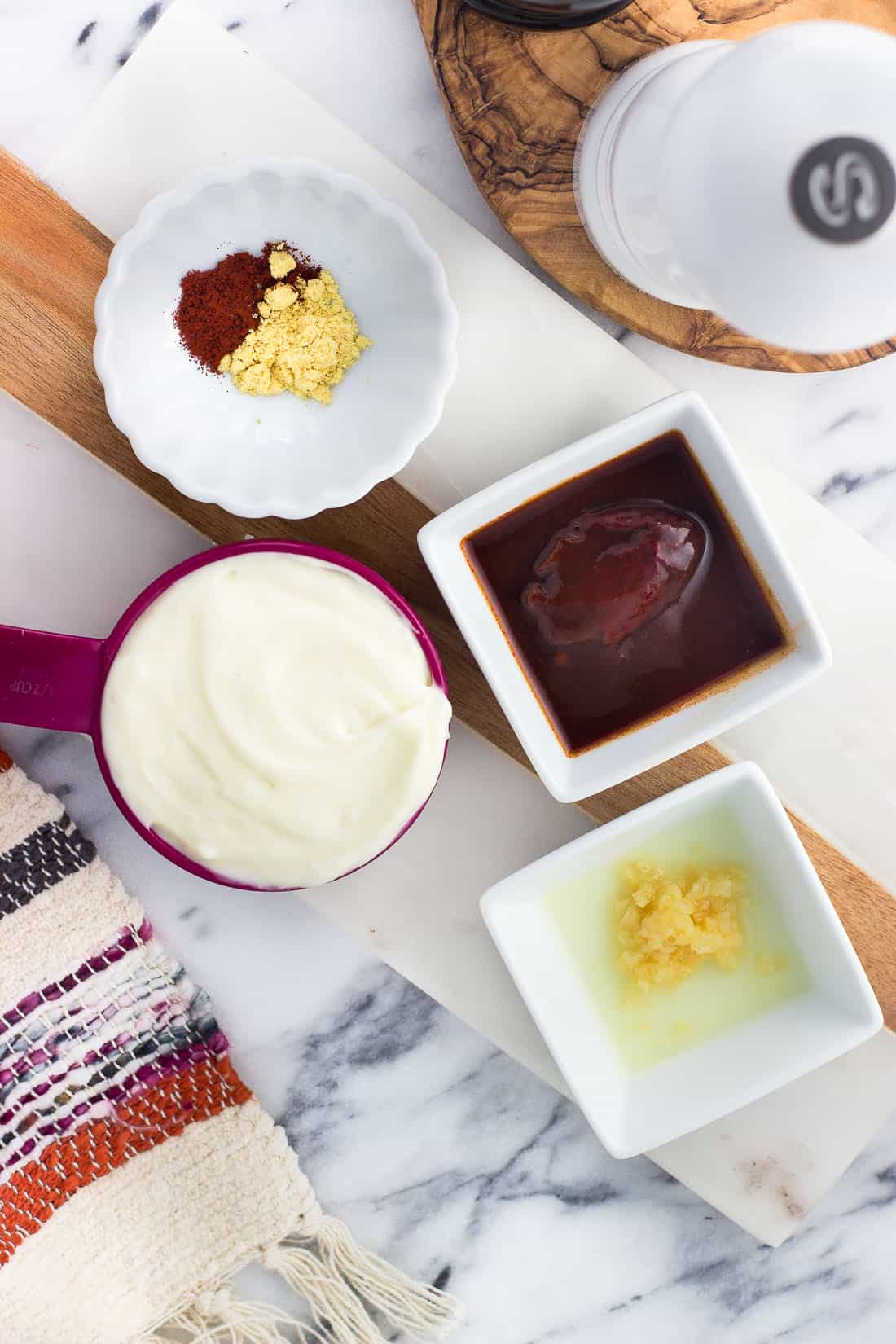 Ingredients in separate bowls on a marble board before being mixed together.