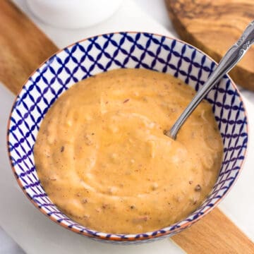 A bowl of chipotle aioli with a small spoon