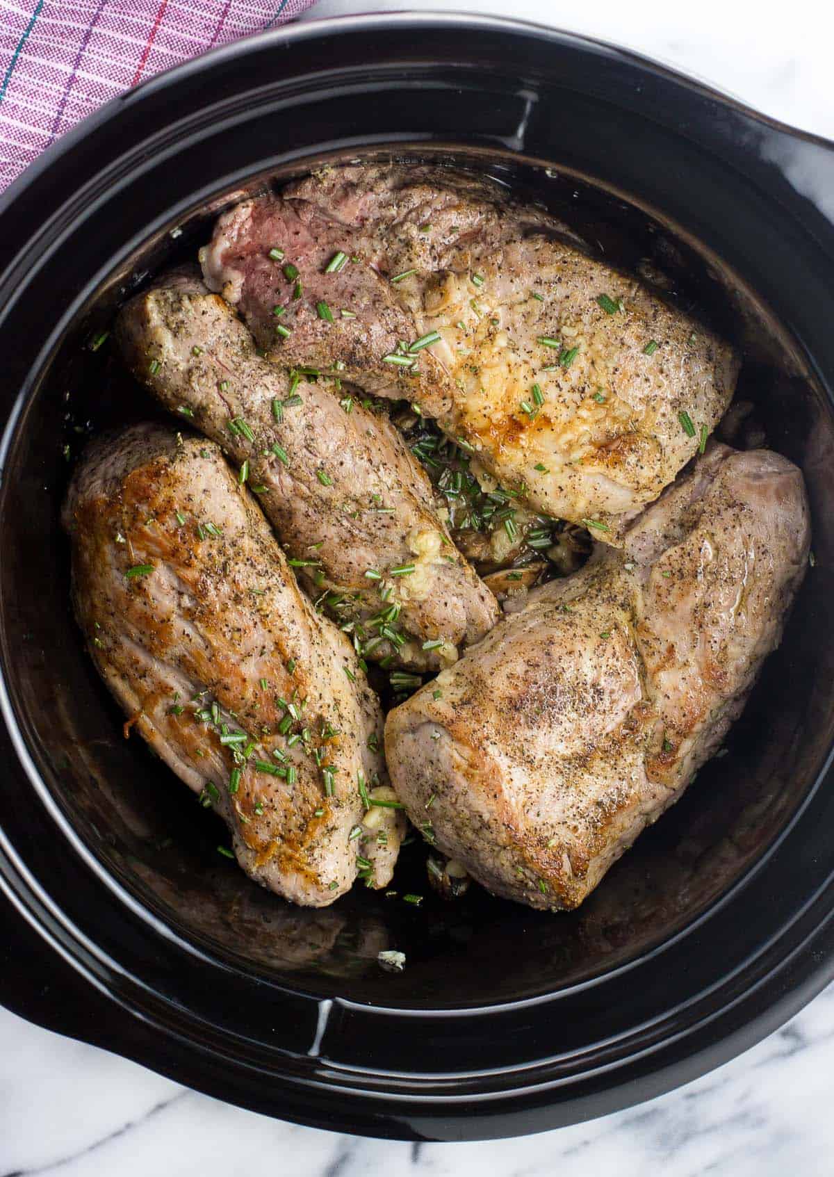 An overhead picture of all ingredients in a slow cooker ready to cook.