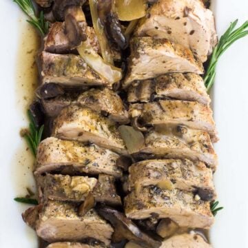 An overhead shot of sliced pork tenderloin on a serving plate