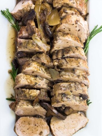 An overhead shot of sliced pork tenderloin on a serving plate